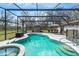 Screened-in pool with spa and outdoor seating; a great place to relax and enjoy the Florida sunshine at 1236 Selman Rd, Leesburg, FL 34748