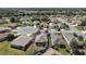 Aerial view of a home's layout, showcasing the patio, landscaping, and proximity to neighboring properties at 12497 Se 92Nd Ave, Summerfield, FL 34491