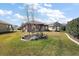 A well-manicured lawn with beautiful landscaping features surrounds this home's comfortable patio at 12497 Se 92Nd Ave, Summerfield, FL 34491