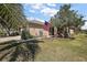 Well-manicured lawn with decorative touches, featuring a flagpole and landscaping at 12497 Se 92Nd Ave, Summerfield, FL 34491