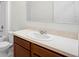 Bathroom featuring a single sink, wood cabinetry, and a neutral countertop at 125 Sunny Day Way, Davenport, FL 33897