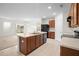 Well-lit kitchen featuring an island with a double sink, and stainless steel appliances at 125 Sunny Day Way, Davenport, FL 33897