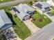 Aerial view of a home with mature landscaping, a two-car garage, and solar panels at 1256 Camero Dr, Lady Lake, FL 32159