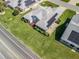 Aerial view of a home with mature landscaping, a two-car garage, and solar panels at 1256 Camero Dr, The Villages, FL 32159