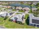 Gorgeous aerial view of home with solar panels overlooking a serene lake in a neighborhood at 1256 Camero Dr, Lady Lake, FL 32159