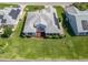 An aerial view of a well maintained house with a manicured lawn and solar panels at 1256 Camero Dr, The Villages, FL 32159