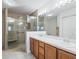 Spacious bathroom featuring a double sink vanity, a glass-enclosed shower, and ample lighting at 1256 Camero Dr, Lady Lake, FL 32159