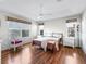 Bright bedroom with wood floors, complemented by neutral walls and natural light streaming through the windows at 1256 Camero Dr, The Villages, FL 32159