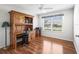 Bright bedroom featuring a wooden desk, ceiling fan, and window with blinds at 1256 Camero Dr, The Villages, FL 32159