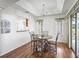 Well-lit dining room featuring a chandelier and a sliding glass door at 1256 Camero Dr, The Villages, FL 32159