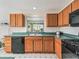 Cozy kitchen with wood cabinets, green countertops, and modern appliances at 1256 Camero Dr, Lady Lake, FL 32159