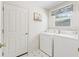 Well-lit laundry room with white appliances and a patterned tile floor at 1256 Camero Dr, Lady Lake, FL 32159