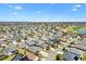 Drone view of a neighborhood, with golf course, and house marked by a red star at 1357 Owl Dr, The Villages, FL 32163