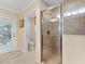 Bright bathroom featuring a glass-enclosed shower with tiled walls and modern fixtures at 1357 Owl Dr, The Villages, FL 32163