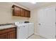 Functional laundry room with modern washer and dryer, cabinets, and a convenient sink area at 1357 Owl Dr, The Villages, FL 32163