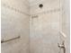 Tiled shower featuring a handrail and shower niche at 1357 Owl Dr, The Villages, FL 32163