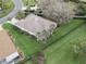 Aerial view of the property showing the layout, lawn, screened patio and surrounding neighborhood at 164 Palermo Pl, The Villages, FL 32159