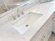 Close-up of white marble countertop with undermount sink and brushed nickel faucet at 164 Palermo Pl, The Villages, FL 32159