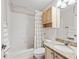 Bright bathroom with a shower-tub combination, granite countertops, and neutral-toned cabinets at 164 Palermo Pl, The Villages, FL 32159