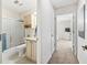 Hallway view of bathroom with tub shower and vanity at 164 Palermo Pl, The Villages, FL 32159