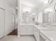 Bright bathroom featuring double sinks with white marble counters and modern fixtures at 164 Palermo Pl, The Villages, FL 32159