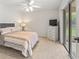 Cozy bedroom with neutral colors and sliding glass door to patio at 164 Palermo Pl, The Villages, FL 32159