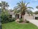 Charming single-story home with a well-manicured lawn and lush tropical landscaping at 164 Palermo Pl, The Villages, FL 32159