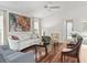 Bright living room with hardwood floors, a ceiling fan, and large windows offering ample natural light at 164 Palermo Pl, The Villages, FL 32159