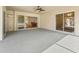 Spacious outdoor carpeted patio featuring an outdoor ceiling fan and sliding glass doors into the home at 164 Palermo Pl, The Villages, FL 32159