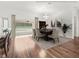 Dining room boasts hardwood floors, neutral paint, a modern chandelier, and glass sliding doors to the screened patio at 164 Palermo Pl, The Villages, FL 32159