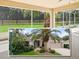 Charming single-story home boasts a two-car garage, and lush landscaping with a beautiful palm tree at 164 Palermo Pl, The Villages, FL 32159