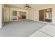 Spacious outdoor patio features an overhead fan and sliding glass doors offering seamless transition to indoor living spaces at 164 Palermo Pl, The Villages, FL 32159