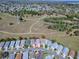 Aerial view of a community featuring well-maintained homes with mature landscaping at 1671 Campos Dr, The Villages, FL 32162