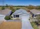 Aerial view of a home with a white picket fence and a well-maintained front yard at 1671 Campos Dr, The Villages, FL 32162