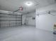 Spacious two-car garage with epoxy flooring and ample storage space at 1671 Campos Dr, The Villages, FL 32162