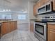 Well-appointed kitchen with stainless steel appliances and a view of the open-concept living area at 1671 Campos Dr, The Villages, FL 32162