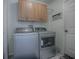 Convenient laundry room with washer, dryer, and storage cabinets at 1671 Campos Dr, The Villages, FL 32162