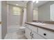 This bathroom includes a tub and shower, toilet and vanity with sink at 17408 Tailfeather Ct, Clermont, FL 34711