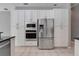 Kitchen featuring stainless steel refrigerator, oven, microwave, and ample white cabinet storage space at 17408 Tailfeather Ct, Clermont, FL 34711