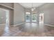 Bright and airy living room with hardwood floors and a view of the backyard pool at 17408 Tailfeather Ct, Clermont, FL 34711