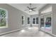 Living room with a ceiling fan, lots of windows for natural light and access to the pool area at 17408 Tailfeather Ct, Clermont, FL 34711