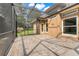 Covered patio with brick pavers, ideal for outdoor seating and enjoying the serene backyard view at 17408 Tailfeather Ct, Clermont, FL 34711