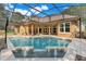 Stunning screened-in pool with water features and ample space for relaxation and entertainment by the lanai at 17408 Tailfeather Ct, Clermont, FL 34711