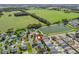 Overhead view of a home's location near a large pond and open fields at 17442 Se 79Th Lovewood Ave, The Villages, FL 32162