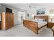 Bright bedroom featuring wood furniture, ceiling fan, and decorative wall art, creating a cozy and inviting space at 17442 Se 79Th Lovewood Ave, The Villages, FL 32162