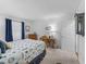 A well-lit bedroom featuring a desk, dresser, nautical bedding, neutral carpet and curtains at 17442 Se 79Th Lovewood Ave, The Villages, FL 32162