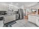 Well-lit kitchen featuring stainless steel appliances and seamlessly connecting to the dining area at 17442 Se 79Th Lovewood Ave, The Villages, FL 32162