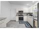 Kitchen featuring stainless steel appliances, white cabinetry, and a modern countertop at 17442 Se 79Th Lovewood Ave, The Villages, FL 32162