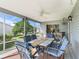 View of lanai with ceiling fan, outdoor seating and view of a manicured lawn and blue skies at 17442 Se 79Th Lovewood Ave, The Villages, FL 32162