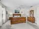 Spacious main bedroom boasts a neutral color scheme, a ceiling fan, and plenty of natural light at 17442 Se 79Th Lovewood Ave, The Villages, FL 32162